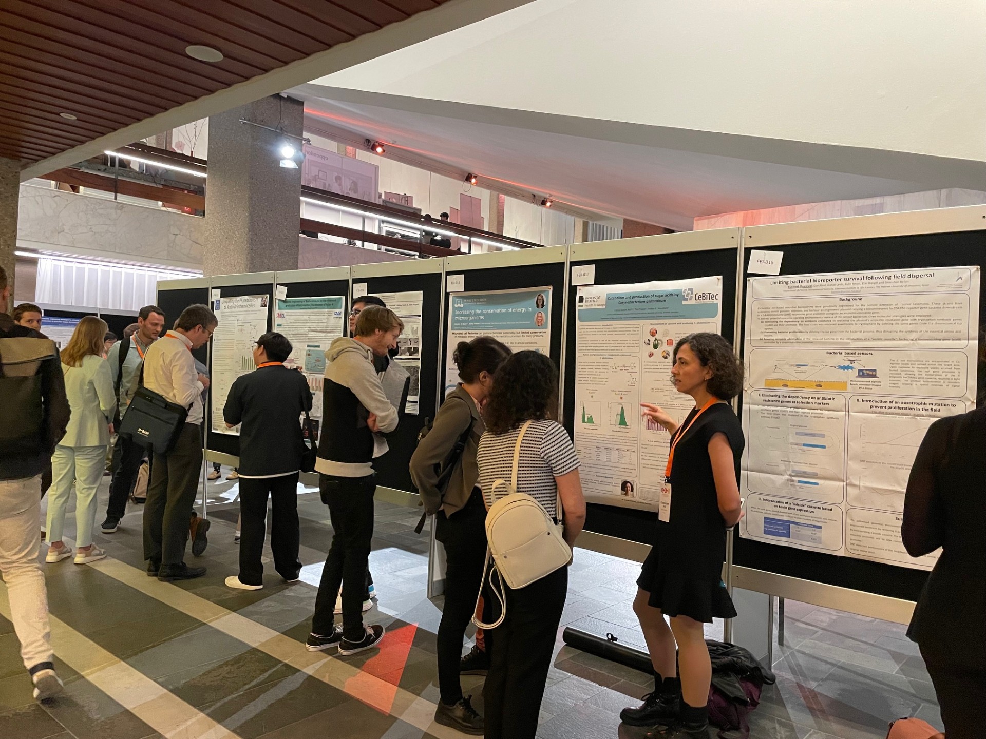 Attendees discussing research posters during networking session at European Congress on Biotechnology